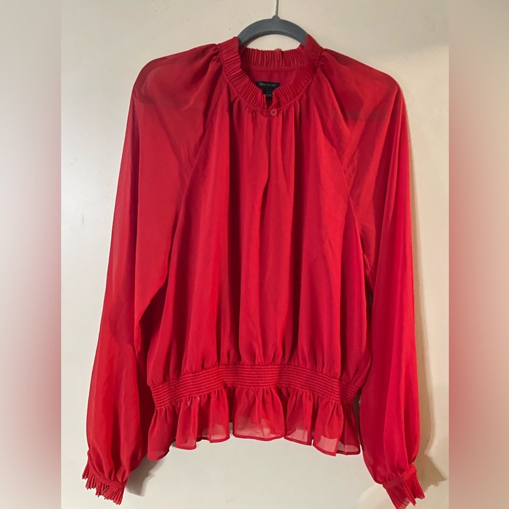 Ann Taylor, womens size large. Beautiful ruffle detailing on sleeves and neck.